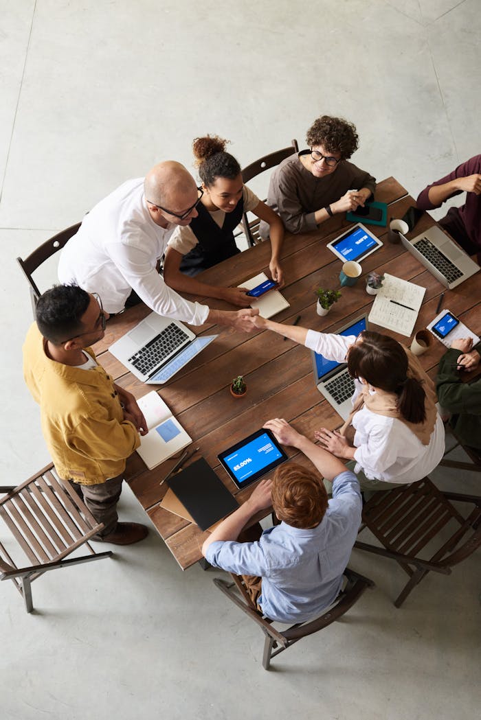 why-choose-us Overhead shot of a diverse team collaborating in a modern office meeting.