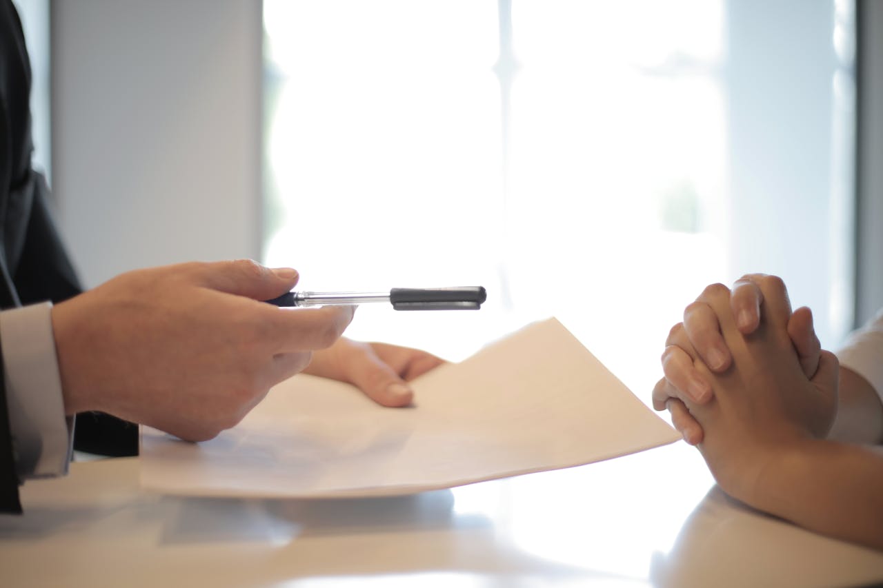 hero-img-01 Close-up of a contract signing with hands over documents. Professional business interaction.